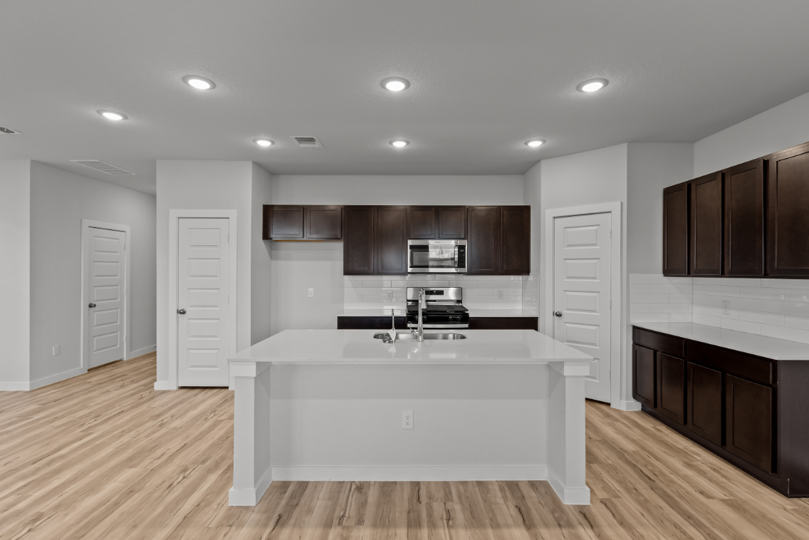 A large kitchen with a white counter.