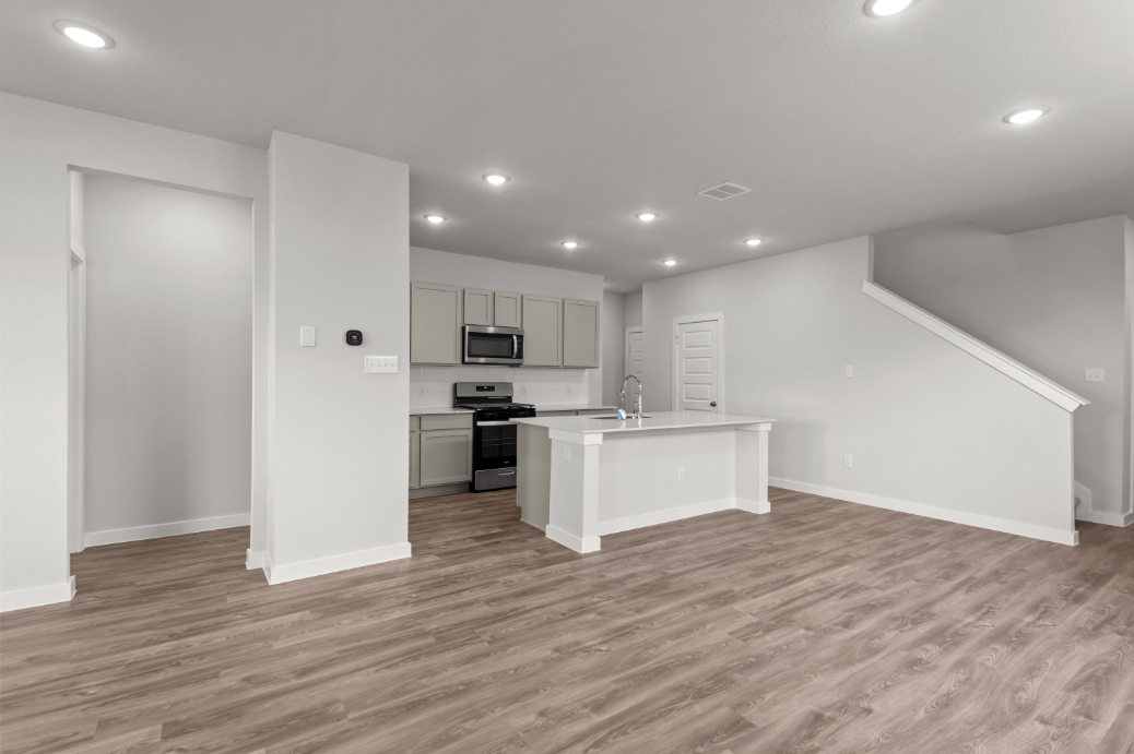 A kitchen with white cabinets.