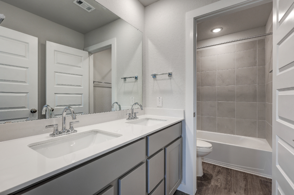 A bathroom with a tub sink and toilet.