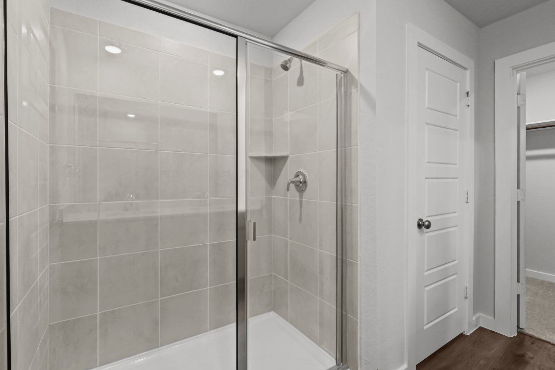 A shower with a glass door.