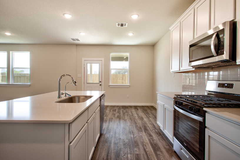 A kitchen with white cabinets.
