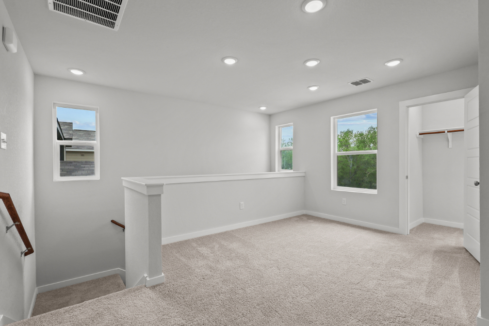 A room with a white couch and a white table.