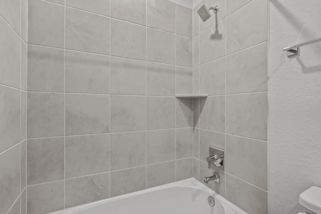A bathroom with a bathtub and toilet.