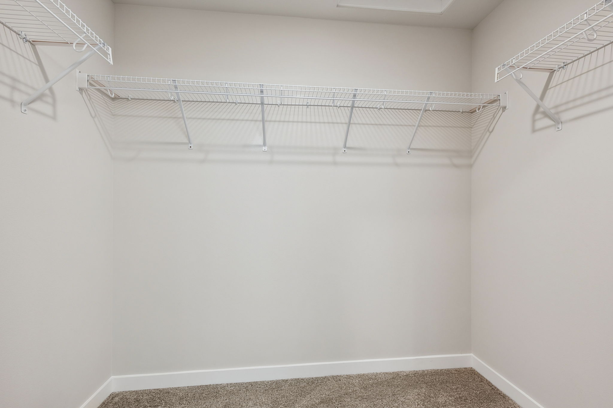 A white wall with a metal railing.