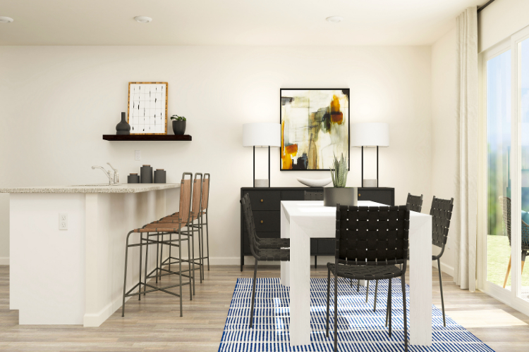 A dining room with a table and chairs.