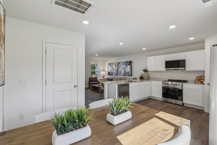 A kitchen with white cabinets.