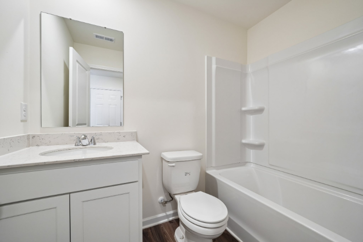 A bathroom with a toilet and sink.