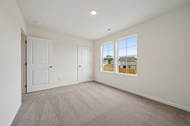 A room with white doors and a window.