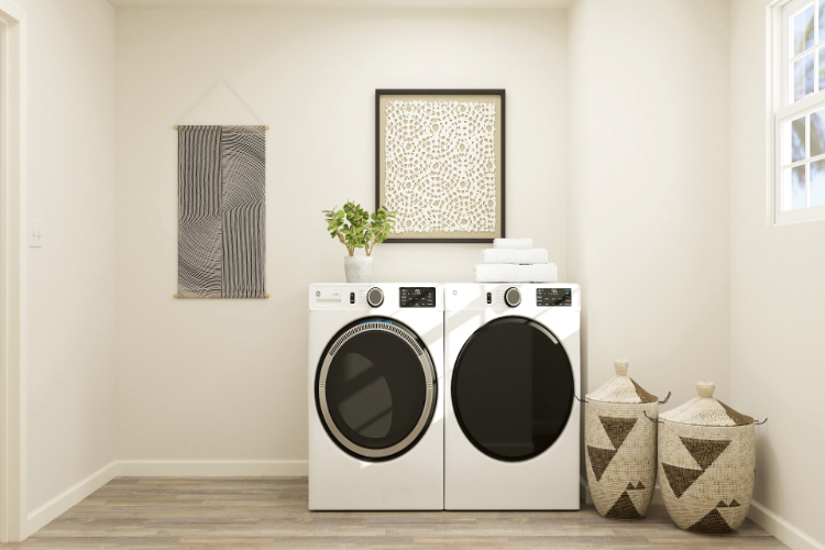 A white laundry room with a black and white washer and dryer.