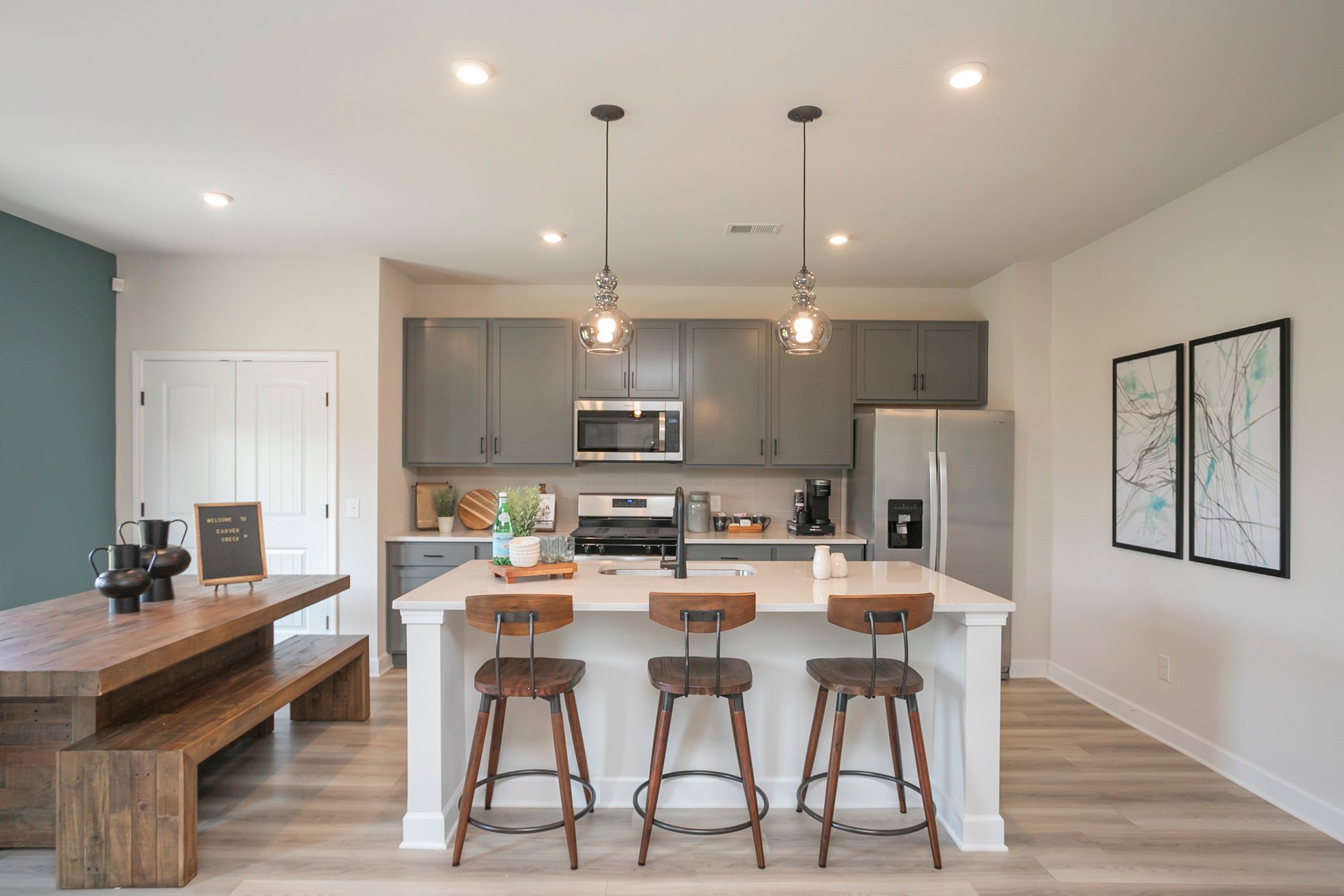 A kitchen with a bar and stools.